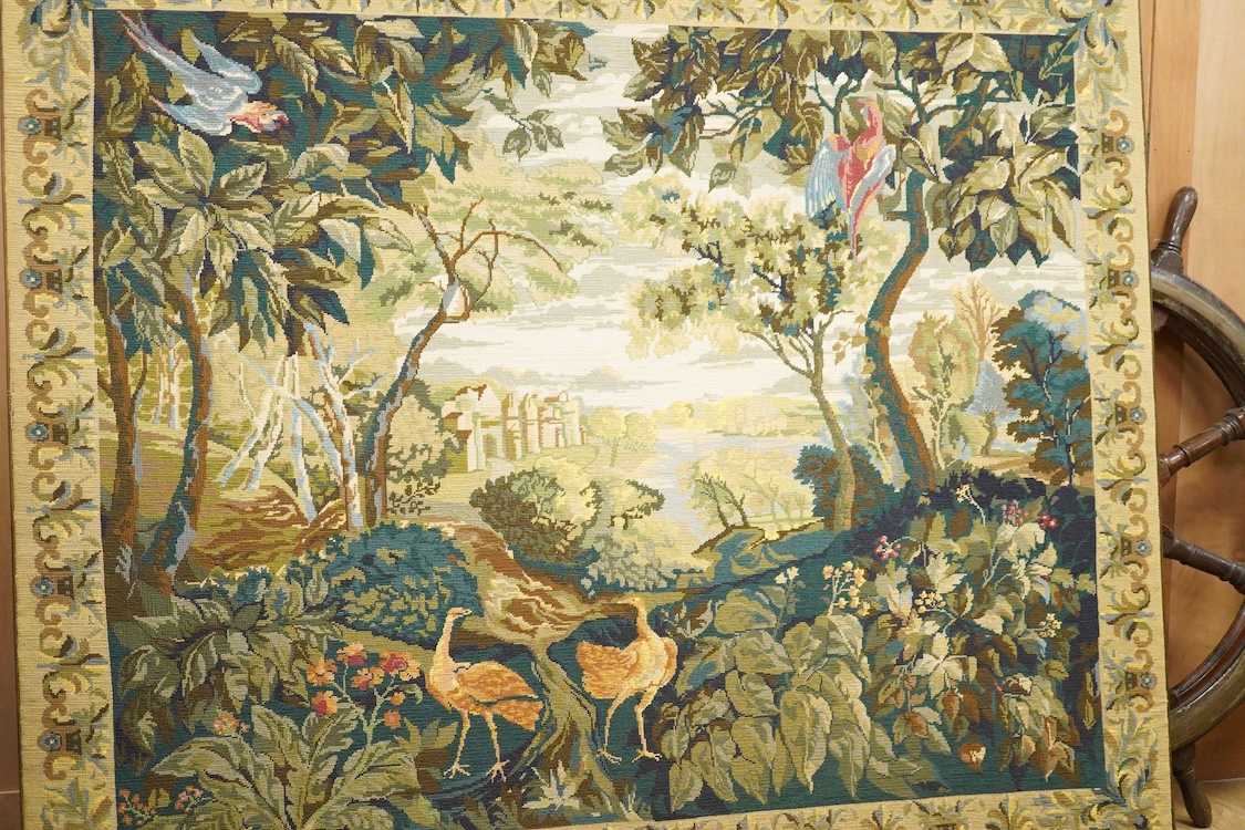 A large framed gross point wool work panel, designed in a verdure foliate palette as a classical French landscape. 161cm wide x 132 cm high.